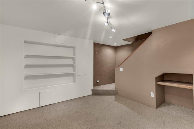 interior space with rail lighting and stairway
