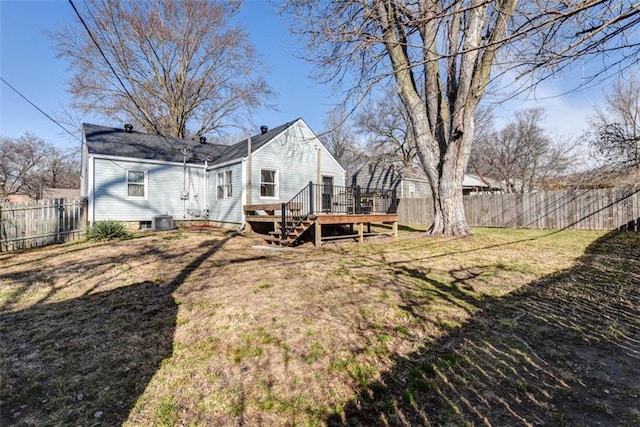 rear view of house featuring a deck, a yard, fence, and cooling unit