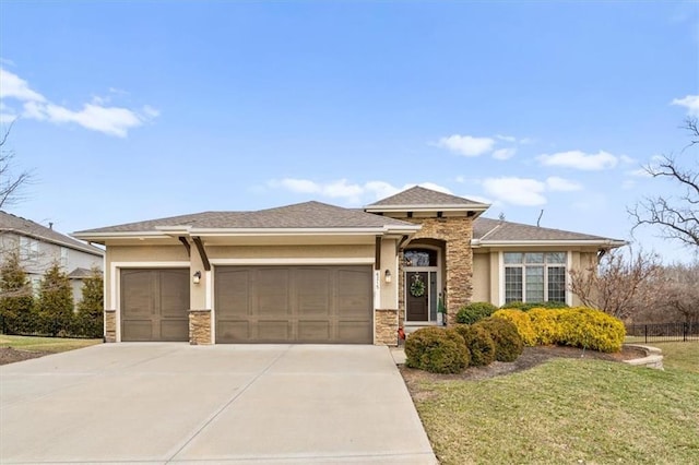 prairie-style house featuring an attached garage, concrete driveway, stone siding, stucco siding, and a front lawn