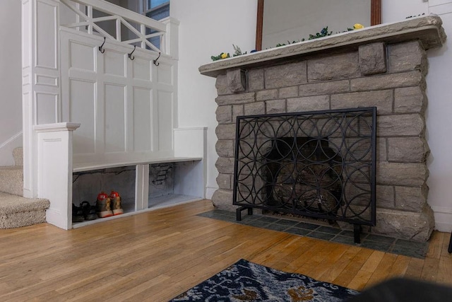 details with a fireplace and wood finished floors