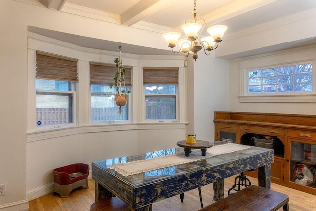 dining space with baseboards, beamed ceiling, light wood-style flooring, and a notable chandelier