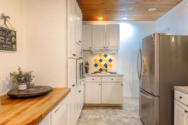 kitchen featuring wooden ceiling, recessed lighting, wooden counters, freestanding refrigerator, and decorative backsplash