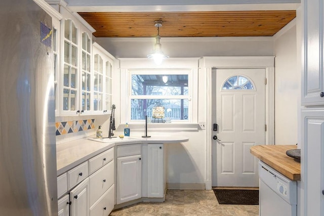 kitchen with butcher block counters, glass insert cabinets, white dishwasher, and wooden ceiling