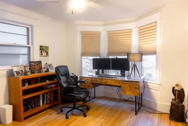 home office featuring ceiling fan, hardwood / wood-style flooring, a wealth of natural light, and baseboards