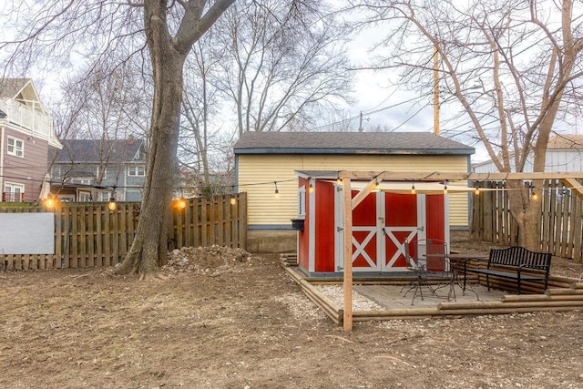 view of shed featuring fence