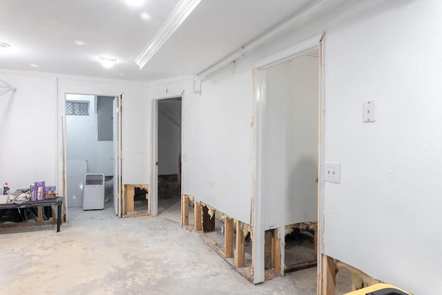 interior space with ornamental molding and unfinished concrete flooring