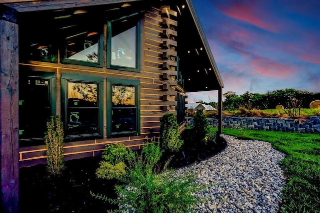 property exterior at dusk with log siding