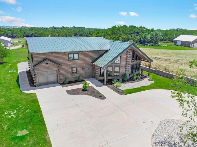 view of front of property featuring metal roof, log exterior, and a standing seam roof