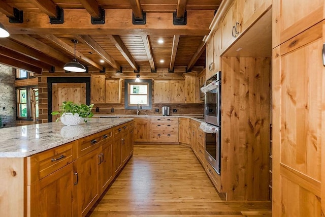 kitchen with light stone countertops, wooden ceiling, light wood-style flooring, and beamed ceiling