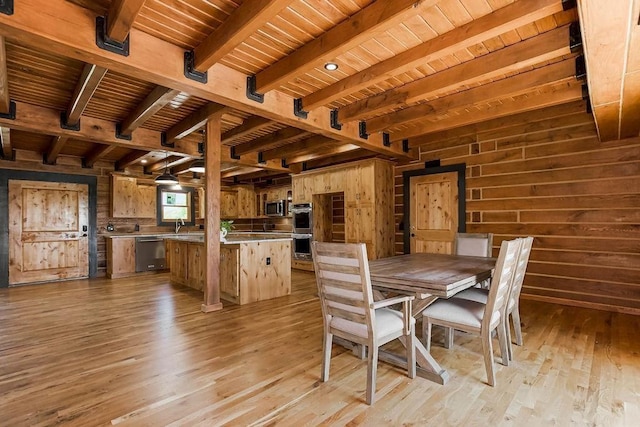 unfurnished dining area featuring wood ceiling, beamed ceiling, and wooden walls