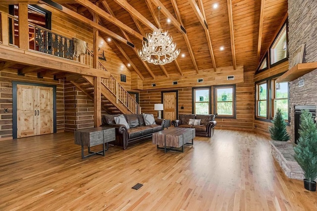 living area with wooden ceiling, beam ceiling, high vaulted ceiling, and wood finished floors