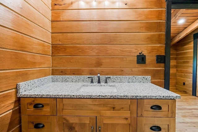 bathroom with wooden walls and vanity