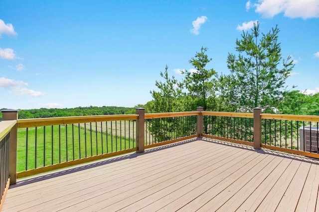 wooden terrace with cooling unit and a lawn