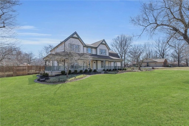 view of front of house featuring a front lawn, a porch, and fence