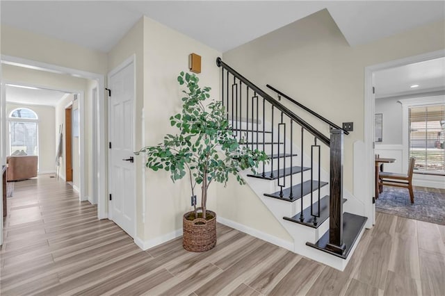 stairs featuring baseboards and wood finished floors