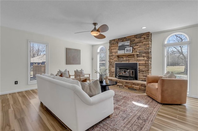 living room with light wood-style floors, a wealth of natural light, and a textured ceiling