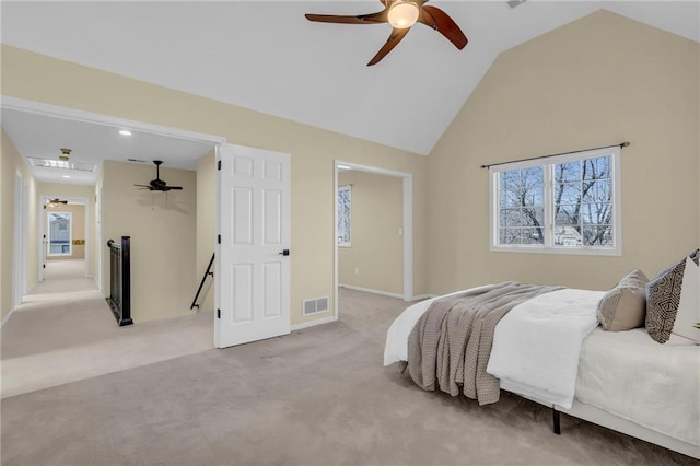 carpeted bedroom featuring vaulted ceiling, baseboards, visible vents, and ceiling fan