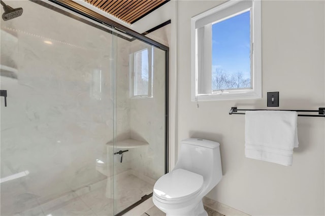 full bathroom with a marble finish shower and toilet