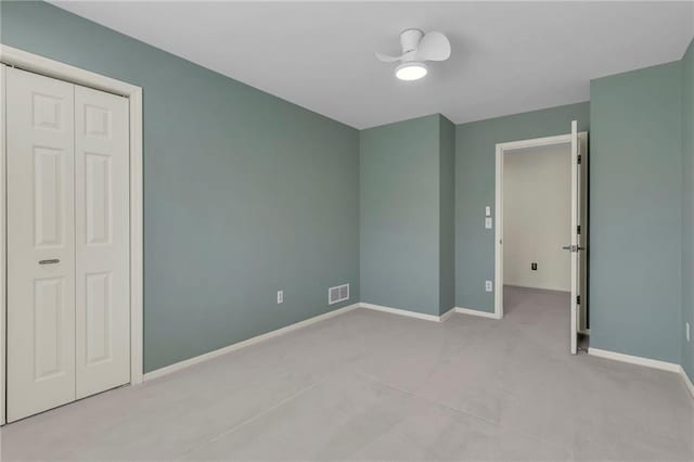 unfurnished bedroom featuring visible vents, baseboards, and a closet