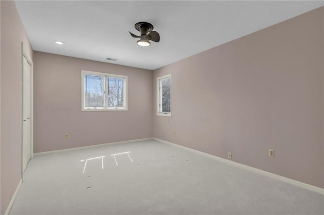 unfurnished bedroom featuring visible vents, light colored carpet, and baseboards