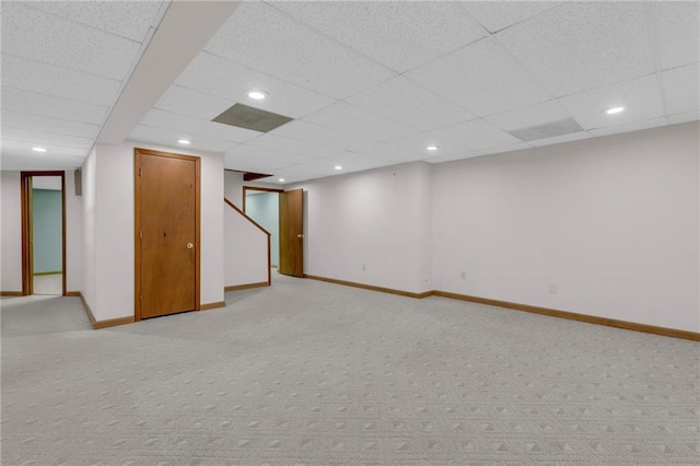 finished basement featuring light carpet, recessed lighting, and baseboards