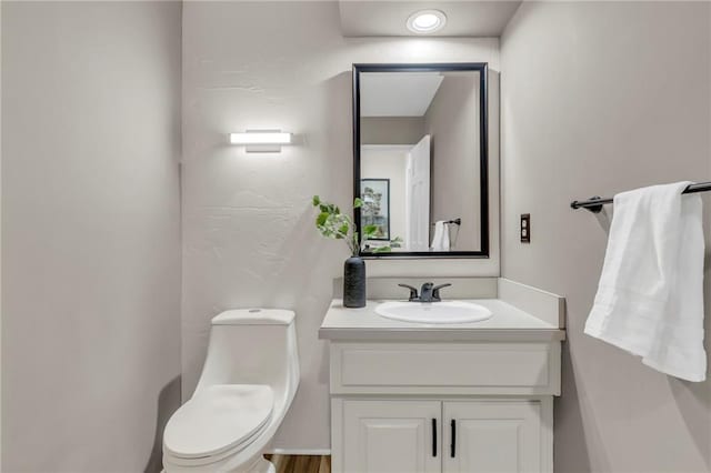 bathroom featuring vanity and toilet