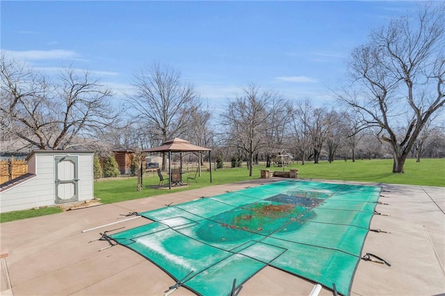 view of swimming pool featuring a gazebo, a lawn, a storage shed, an outdoor structure, and a patio