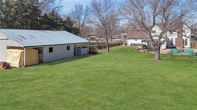 view of yard featuring an outbuilding and an exterior structure