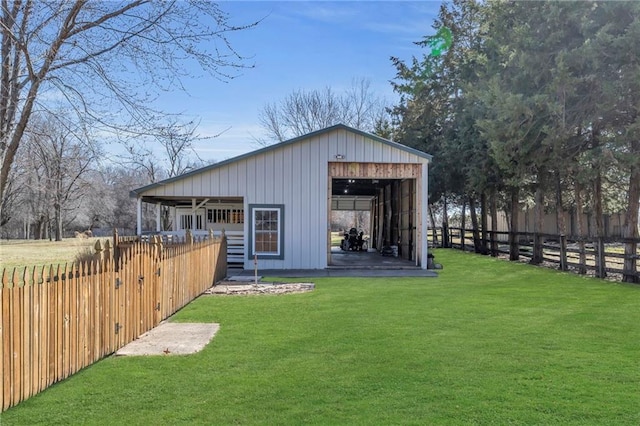 view of pole building with a yard and fence