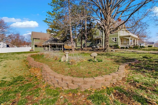 view of yard with fence and a gazebo