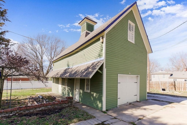 exterior space featuring fence and concrete driveway