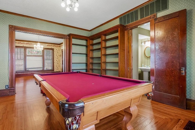 game room with wallpapered walls, pool table, parquet floors, crown molding, and a chandelier