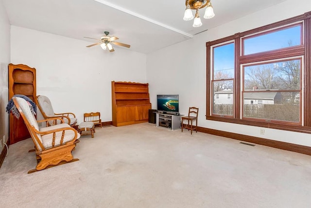 living area with ceiling fan, carpet, visible vents, and baseboards