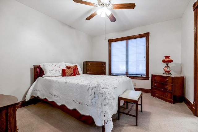 bedroom with baseboards, a ceiling fan, and light colored carpet