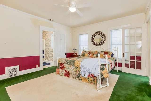 bedroom with ornamental molding, carpet, and visible vents