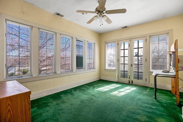 unfurnished sunroom with a ceiling fan, french doors, and visible vents