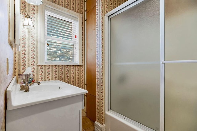 bathroom with tile patterned floors, vanity, and wallpapered walls