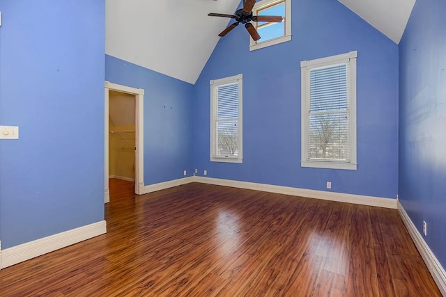 unfurnished room featuring high vaulted ceiling, baseboards, a ceiling fan, and wood finished floors