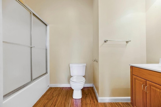 full bath featuring baseboards, vanity, toilet, and wood finished floors