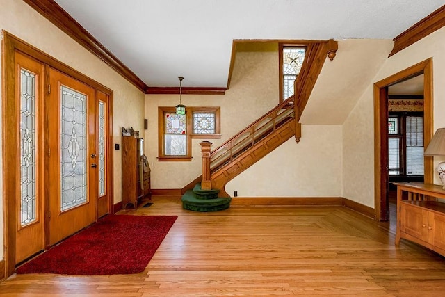 510 E Chippewa St, Paola, KS 66071 - entrance foyer featuring healthy amount of natural light, ornamental molding, light wood-type flooring, and stairs