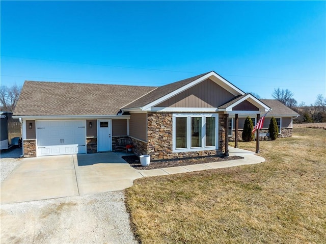 view of front facade featuring roof with shingles, an attached garage, stone siding, driveway, and a front lawn