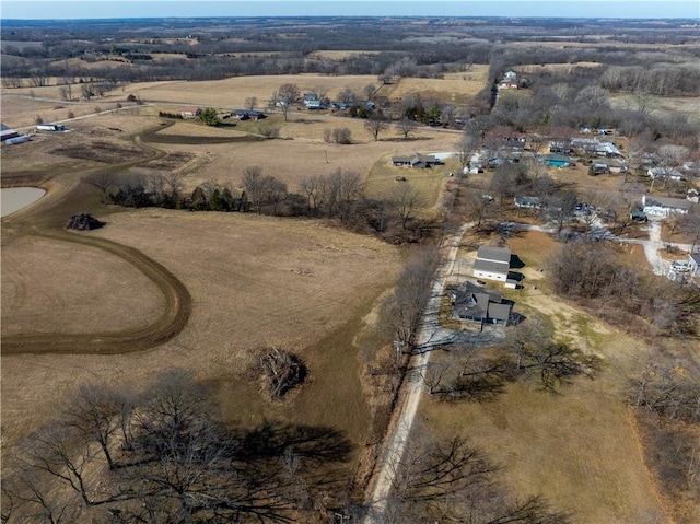 birds eye view of property with a rural view