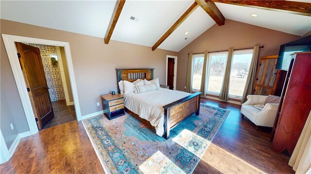 bedroom featuring lofted ceiling with beams, visible vents, baseboards, and wood finished floors