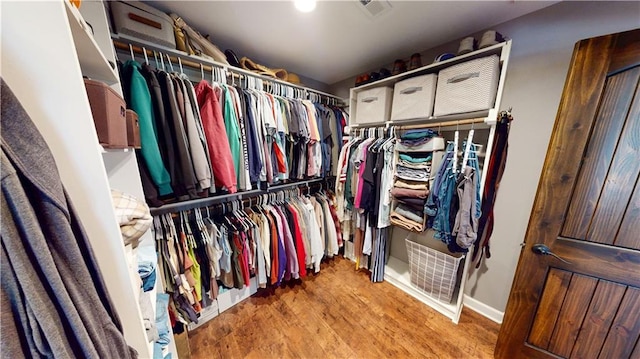 spacious closet featuring visible vents and wood finished floors