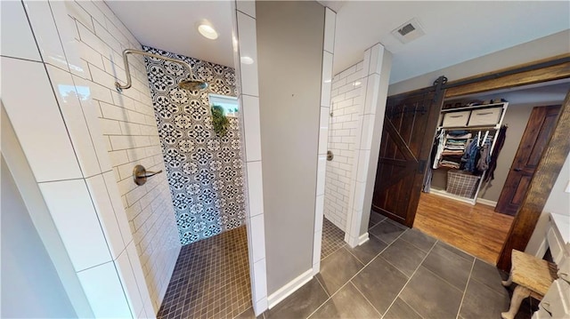 full bath featuring visible vents, tiled shower, and tile patterned floors