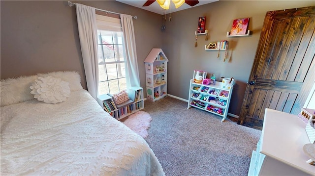 carpeted bedroom featuring ceiling fan and baseboards