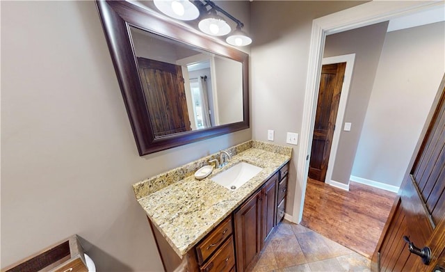 bathroom with baseboards and vanity