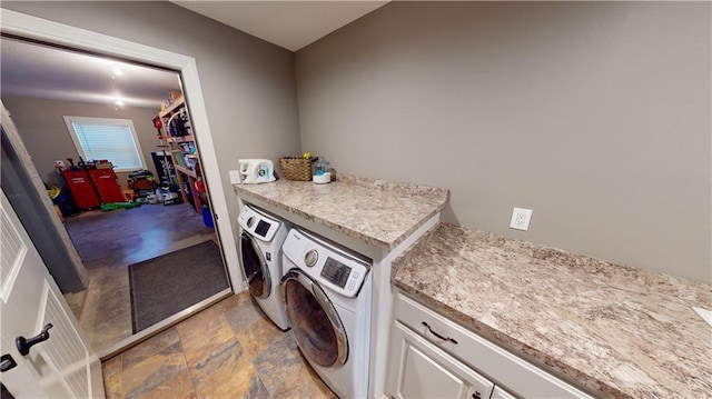 laundry area featuring cabinet space and independent washer and dryer