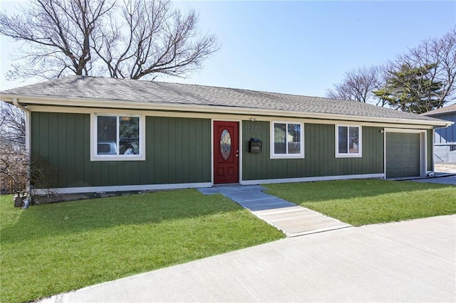 ranch-style home featuring an attached garage, a front lawn, and roof with shingles