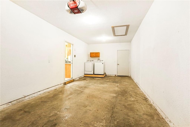 garage featuring separate washer and dryer and a garage door opener